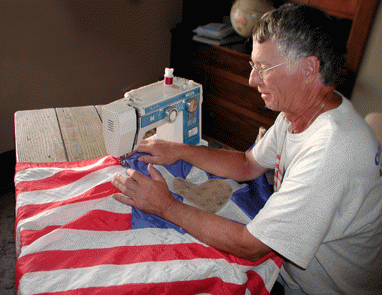 Bob McNary stitches the flag.