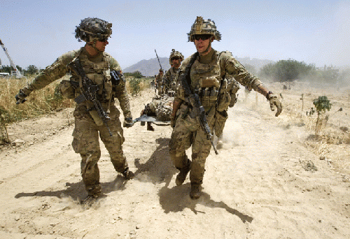 U.S. Army soldiers carry Sgt. Matt Krumwiede, who was wounded by an improvised explosive device (IED), towards a Blackhawk Medevac helicopter in southern Afghanistan June 12, 2012.