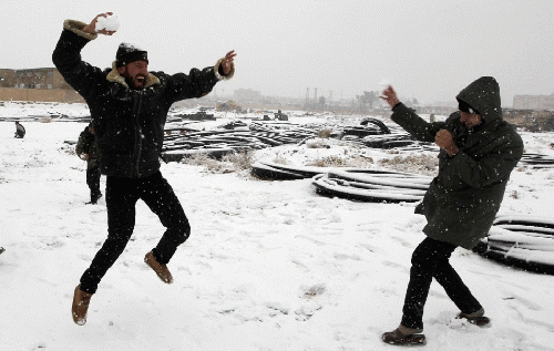 Free Syrian Army fighters play with snow in Raqqa, eastern Syria, From Images