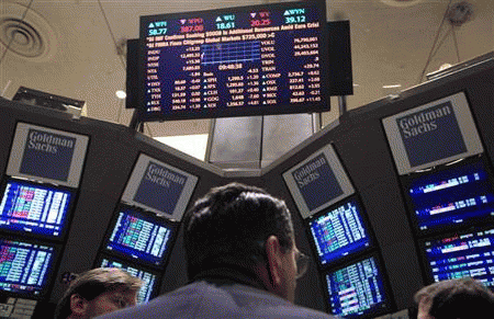 Traders gather at the Goldman Sachs post on the floor of the New York Stock Exchange, January 18, 2012.