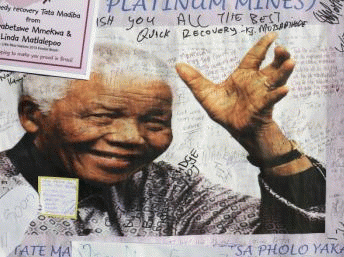 A poster of Nelson Mandela is filled with get well messages outside the Medi-Clinic Heart Hospital in Pretoria, 3 July, 2013 