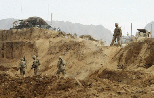 U.S. troops investigate the site of a suicide attack on a NATO base in Zhari, west of Kandahar province, January 20, 201, From Images