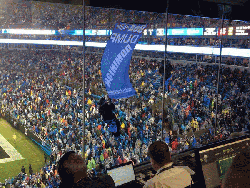 Activists are suspended in front of the press box during Carolina Panthers game., From ImagesAttr