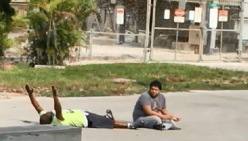 Does it look like this unarmed behavioral therpaist who was doing his job trying to get a patient back to a group home is a threat to anyone? Well the police must have thought so - they shot him, then handcuffed him.