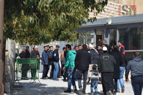 Palestinians are waiting to pass through the new checkpoint at al-Ibrahimi mosque