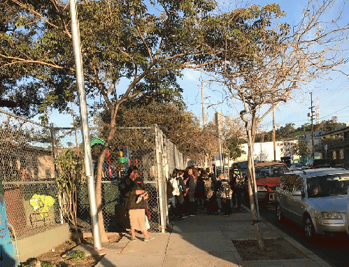 Charter school students line up to enter the Ann Street School separate from their public school counterparts.