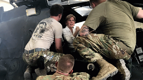 Senator Elizabeth Warren speaks to US troops while seated in a US military helicopter during a trip to the Middle East.