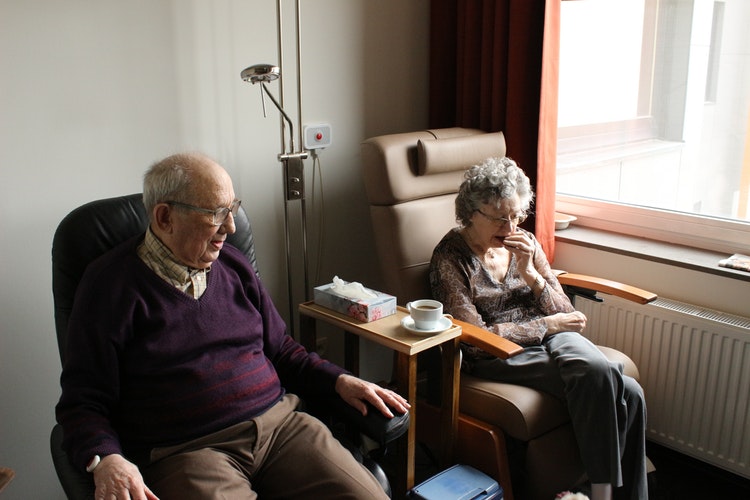 Elderly man and woman sitting, From InText