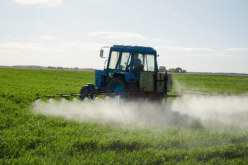 Tractor spraying field