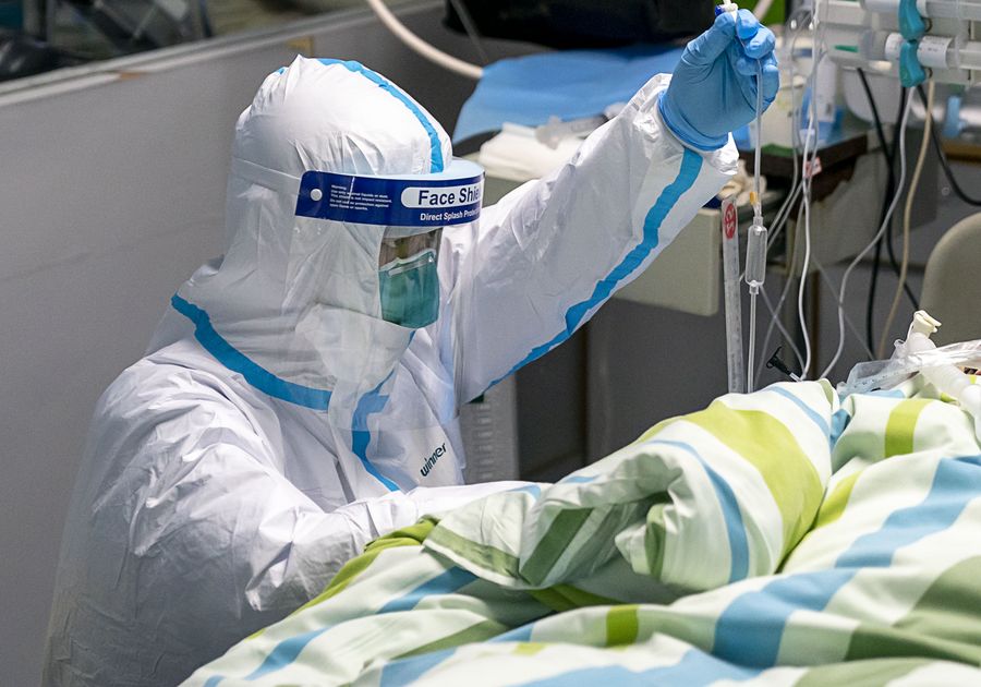 A medical worker gives a patient medical treatment in the ICU in Zhongnan Hospital of Wuhan University in Wuhan