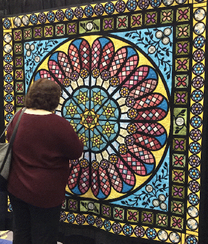 A visitor checks out 'Between Heaven and Earth' by Audra Rasnake, which received a Judge's Choice ribbon.