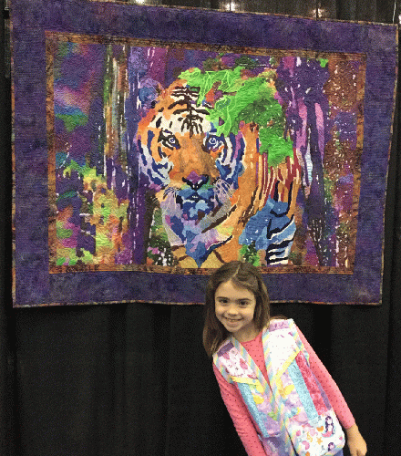 The author's granddaughter with Rajah by Leigh A Layton. Six year old Myla is wearing a quilted vest she stitched herself!