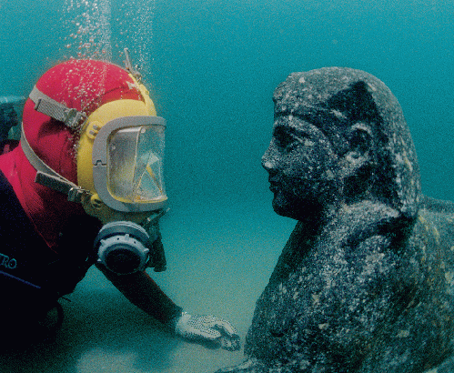 Archeologist eye to eye to with a sphinx underwater. The treatment of the face is characteristic of royal effigies blending the Pharaonic traditions with the Hellenistic portrait style. This Sphinx could be a portrait of the father of Cleopatra VII, the '