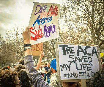 From live.staticflickr.com: 2017Rally in Support of Affordable Care Act. Signs say: The ACA Saved My Life and Still Does and Don't Make America Sick Again  