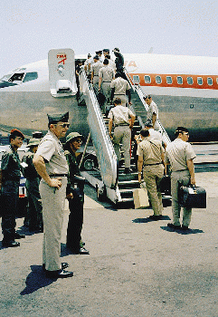 SAIGON 1973 - In a curious ending to a bizarre conflict, American troops boarded jets under the watchful eyes of North Vietnamese and Viet Cong observers in Saigon