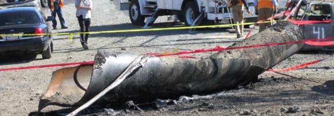 Figure 17: San Bruno exploded pipe. The pipe blew into the air from the crater, and landed 100 feet away from the crater.