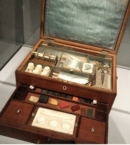 A George III Satinwood Combination Sewing and Painting Box c. 1800  Wood, satin fabric, metal tools for sewing and watercolor pigment blocks, stone, glass, and ceramic