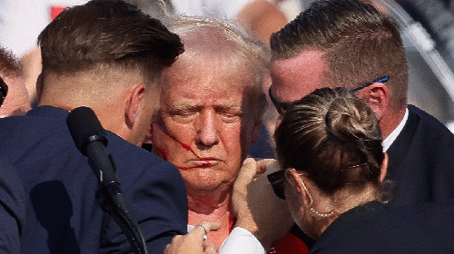 Republican presidential candidate and former President Donald Trump is assisted by security personnel after gunfire rang out during a campaign rally at the Butler Farm Show in Butler, Pennsylvania, on July 13, 2024., From Uploaded